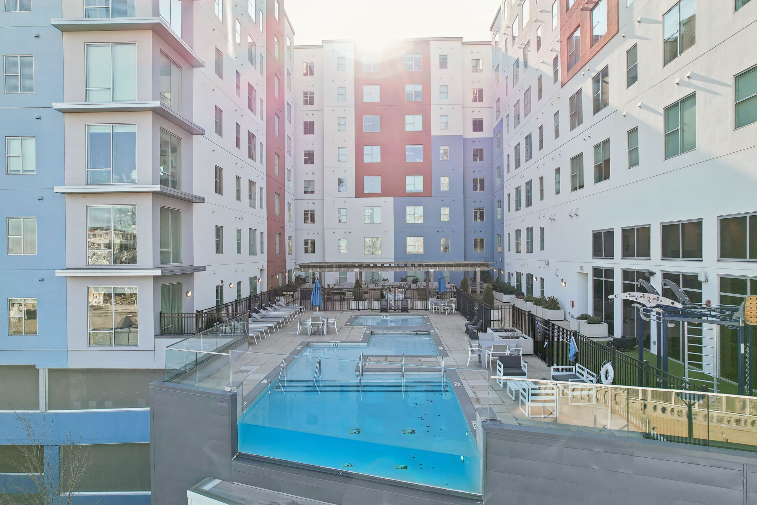 Sunlit courtyard pool between Haven's residential wings