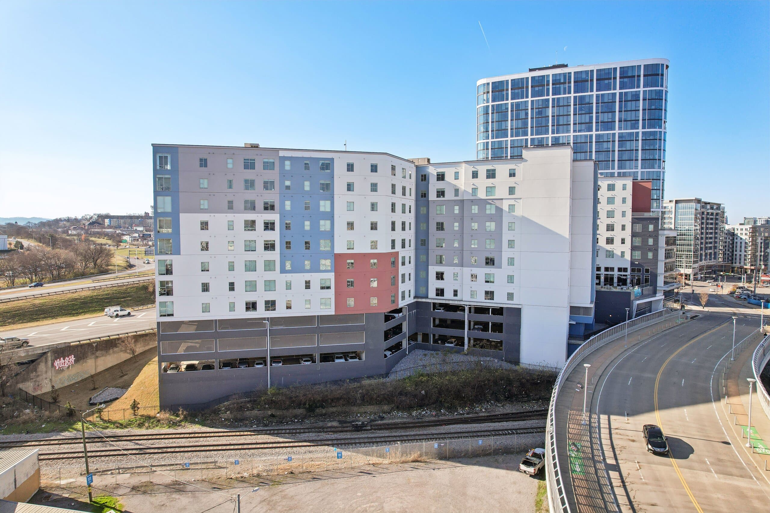 Haven's facade beside the curved glass tower next door