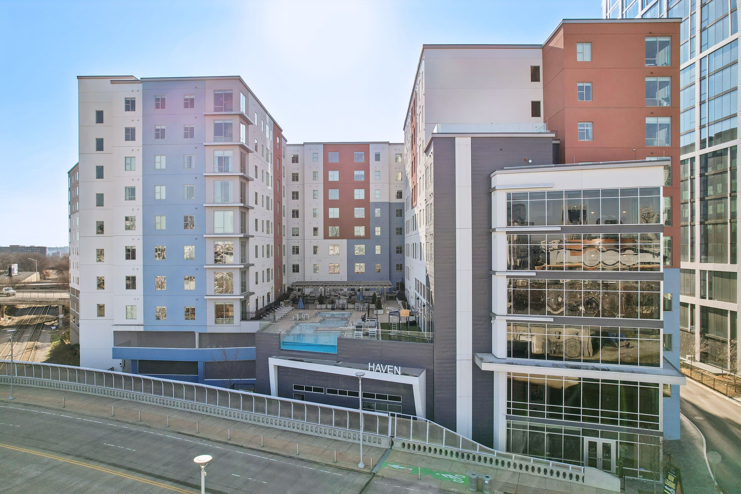 Glass-walled entrance of Haven at The Gulch with the courtyard pool visible above